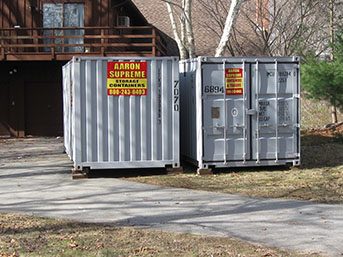 two gray shipping containers at residence
